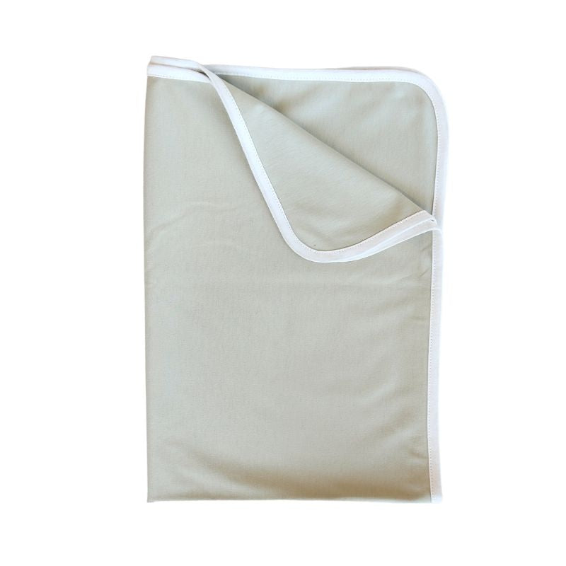 A sage baby swaddle with white trim, folded up with one corner folded down